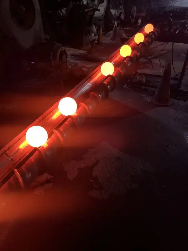 Grinding balls glowing red during the isothermal holding process.