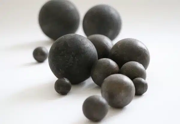 Forged grinding balls of different diameters displayed on white background