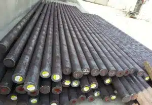 Neatly stacked steel grinding rods with labeled ends, ready for use in rod mills for ore processing.