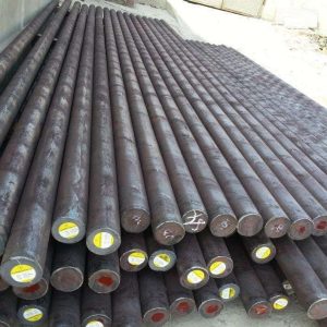Neatly stacked steel grinding rods with labeled ends, ready for use in rod mills for ore processing.