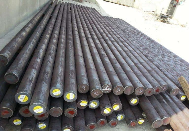 Neatly stacked steel grinding rods with labeled ends, ready for use in rod mills for ore processing.