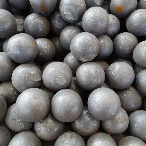 A pile of cast steel grinding balls, showing spherical shapes and varying sizes, typically used in grinding mills. These balls are ideal for industrial grinding applications such as cement and mineral processing.