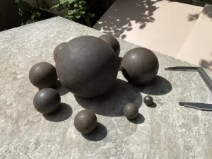 Forged high carbon steel grinding balls for mining and milling.
